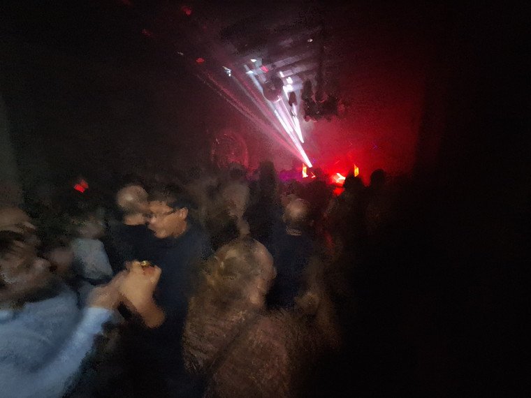 Crowd dancing beneath the castle vaults