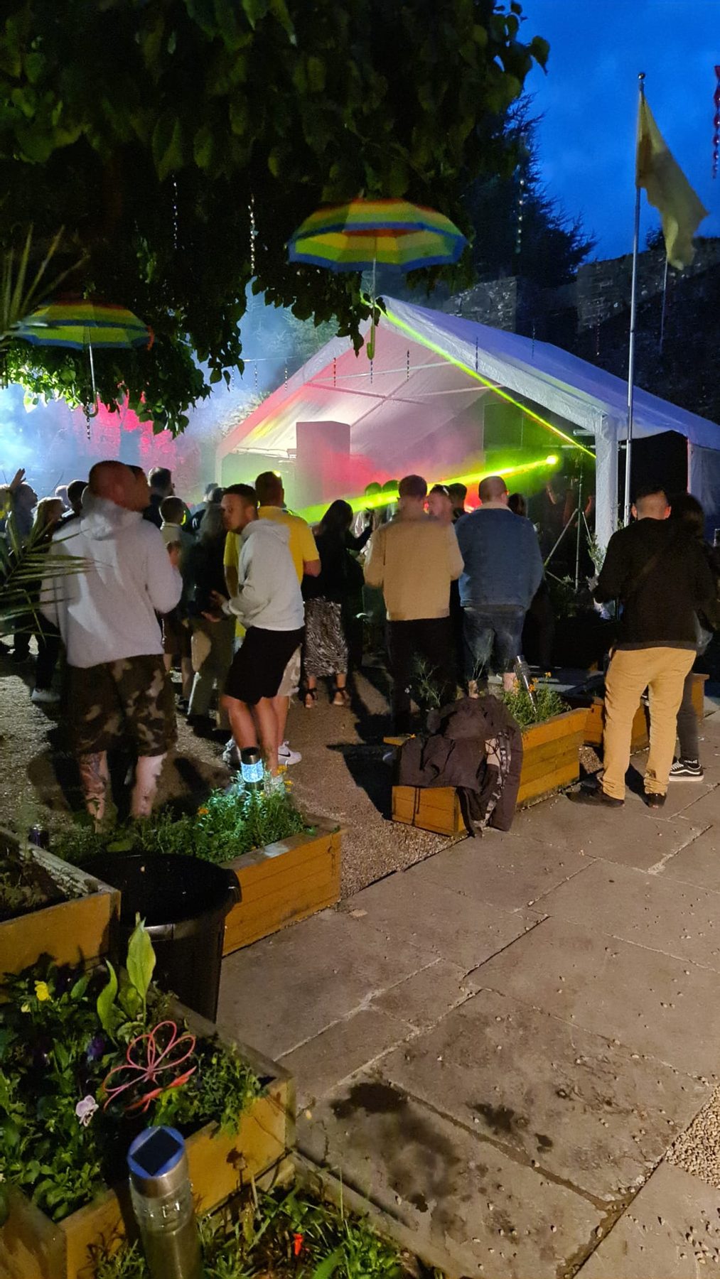 Summer evening crowd by the marquee at Mains Castle