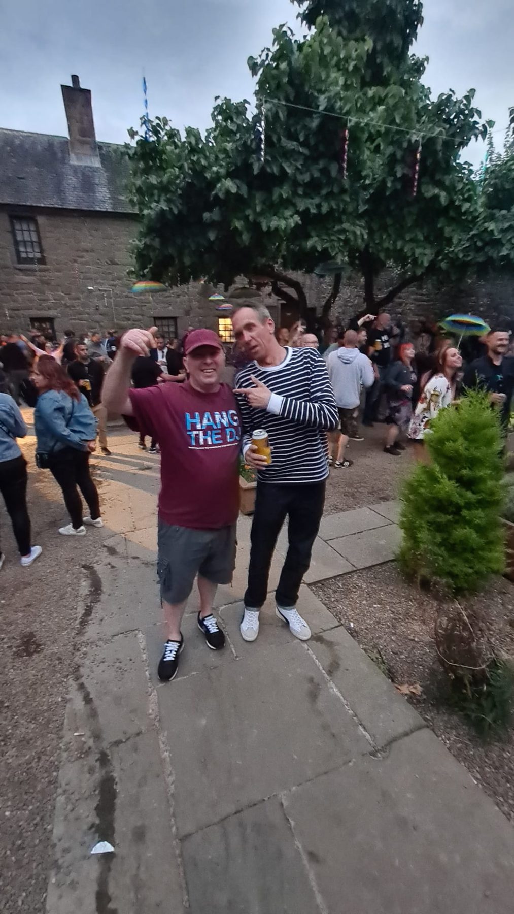 Crowd spilling across the courtyard between sets