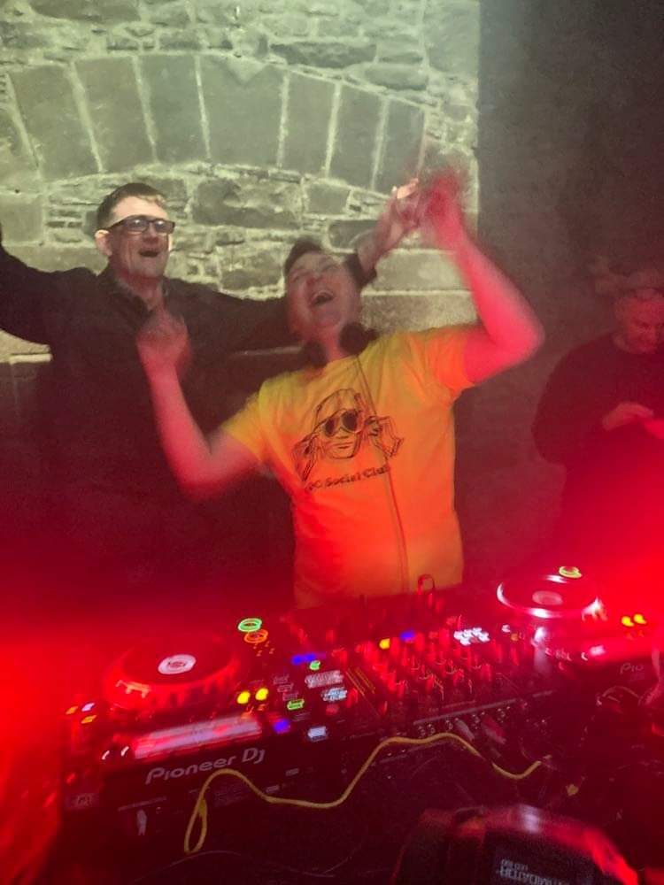 DJ working the mixer as the crowd cheers