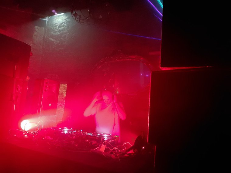 DJ set under red light inside the castle
