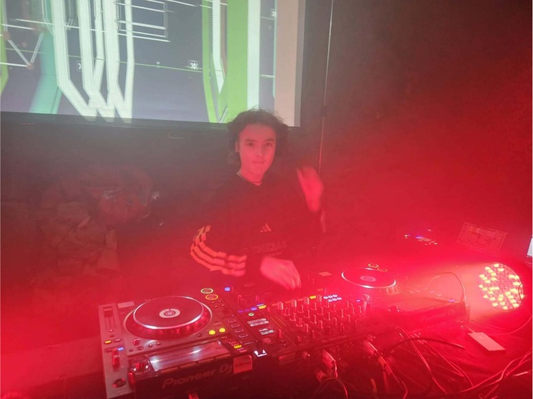 Josh Montague behind the decks in red light