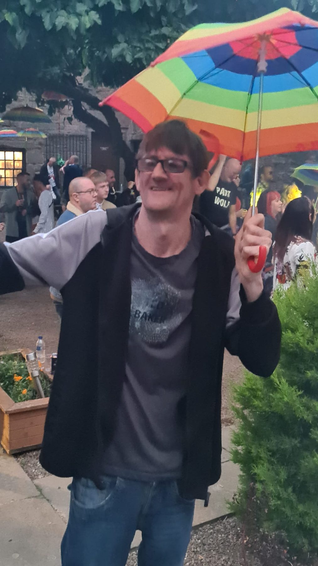 Raised rainbow umbrella above the daytime dance floor