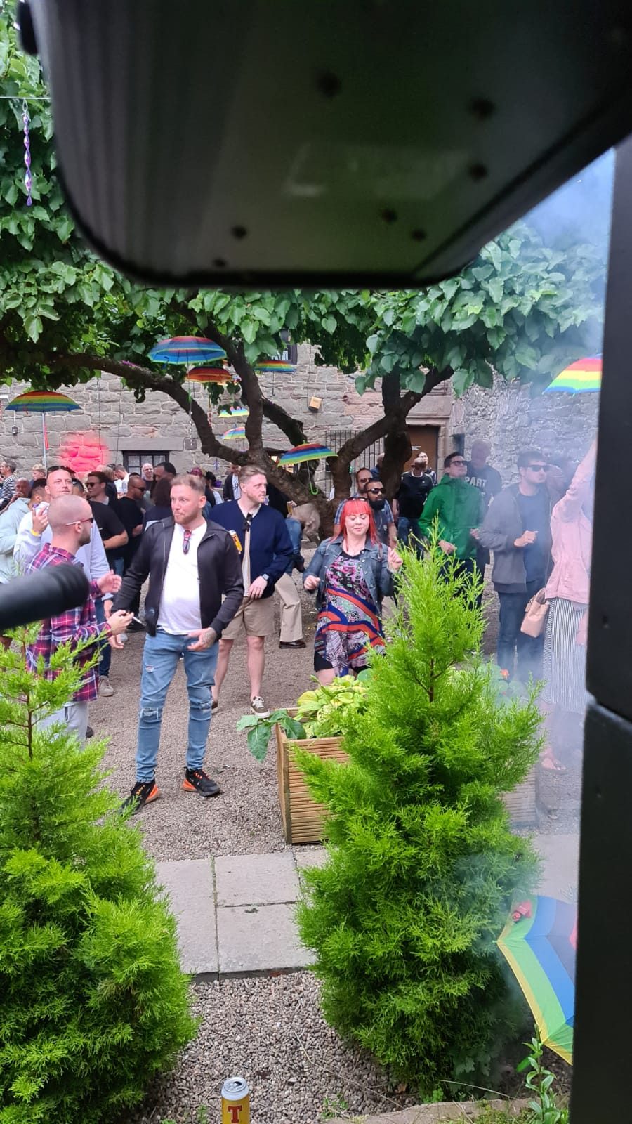 Dancers in the castle garden with smoke drifting through the trees