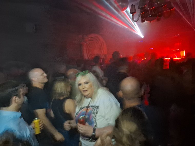 Hands in the air as lasers cut across the crowd